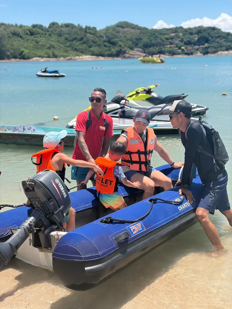 Our crew in red shirts readying the tender and life jackets for guests on the beach