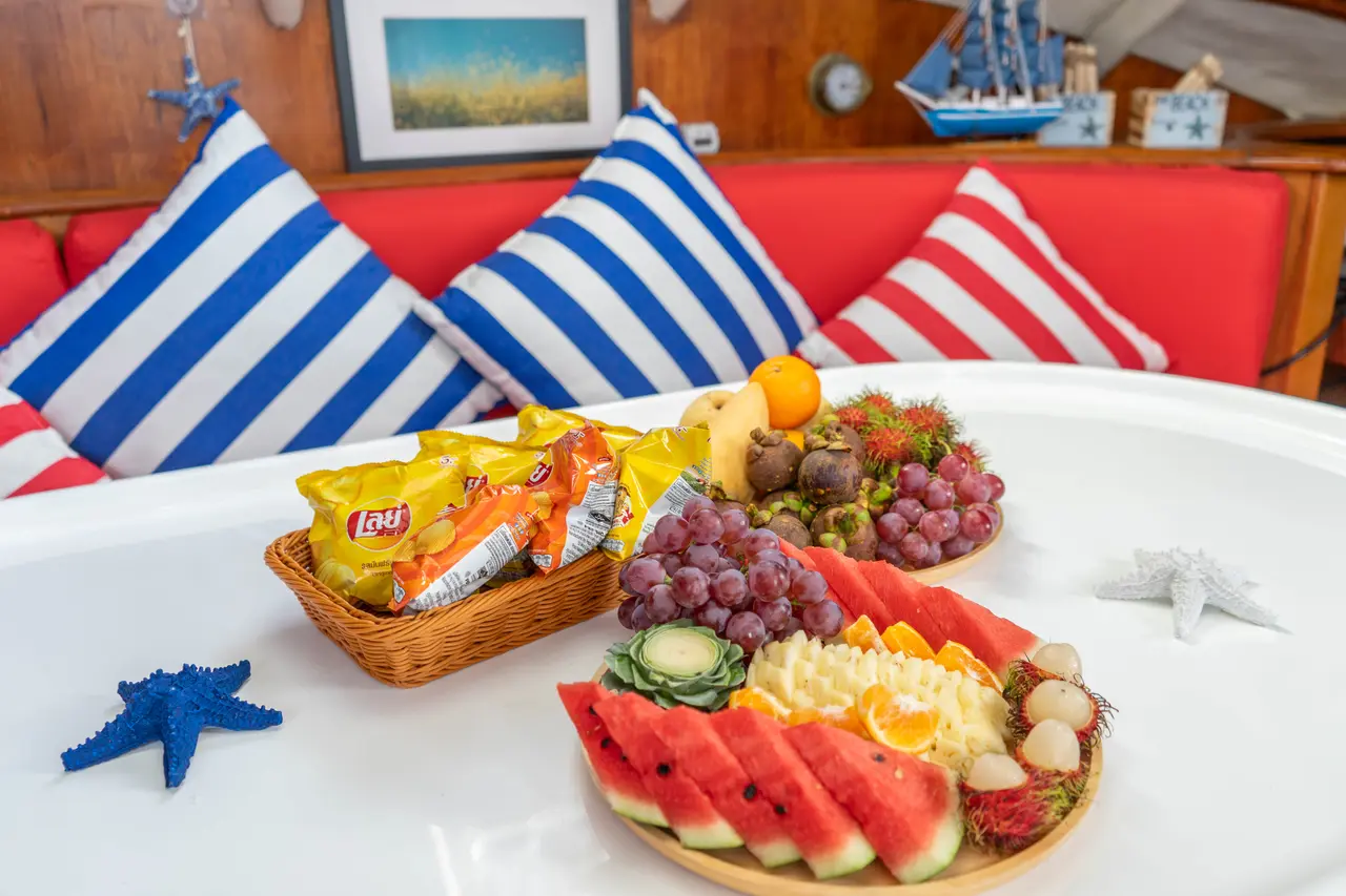 A fruit and snack basket on the table aboard