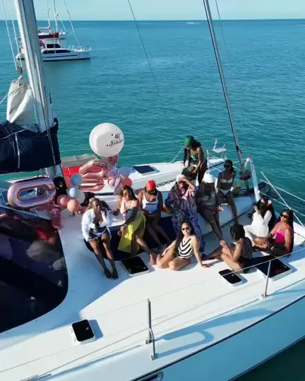 A group celebrating together on deck with balloons