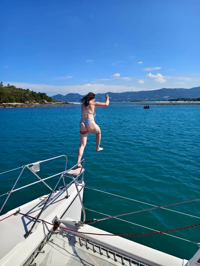 A guest leaping from the bow into the sea