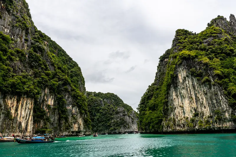 An emerald lagoon ringed by limestone cliffs