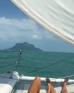 Guests resting on the deck of Nina, a 15-guest sailing catamaran yacht