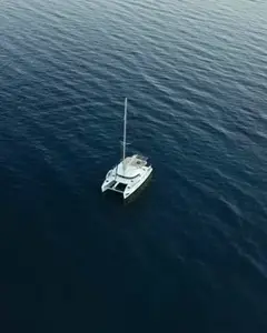 Victoria, a 13-guest sailing catamaran yacht, seen from above on open water