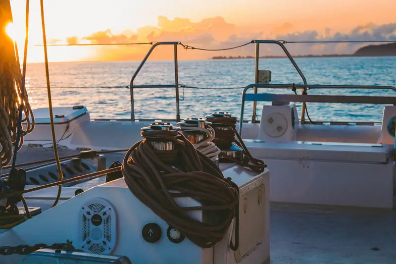 The white deck of a yacht in golden evening light