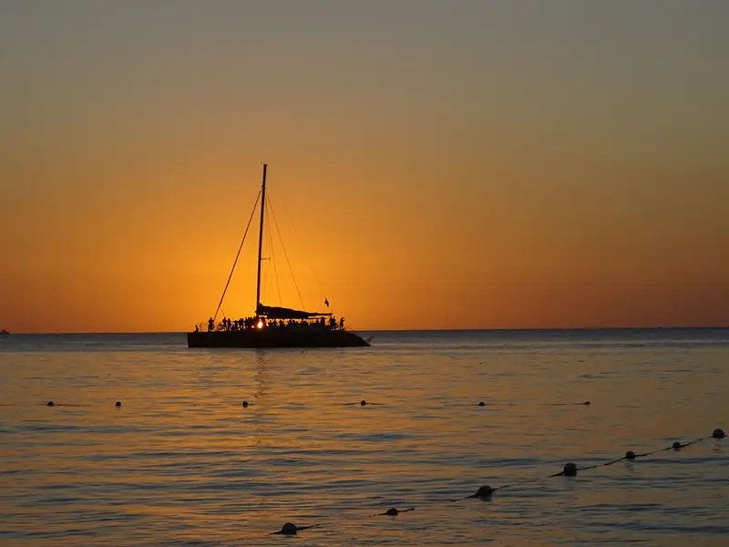 A sailing boat silhouetted against the sunset