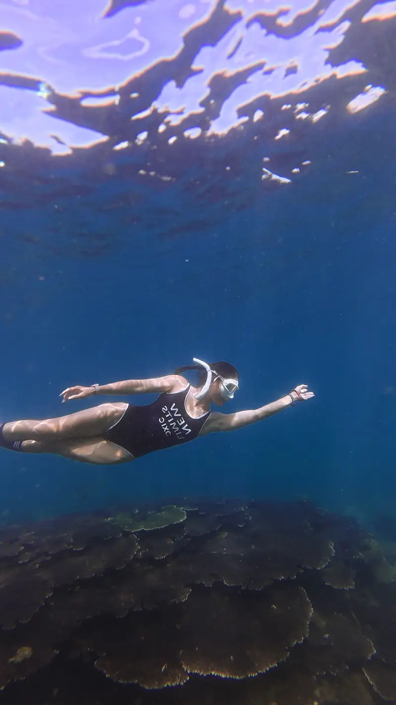 A snorkeller over a vibrant coral reef